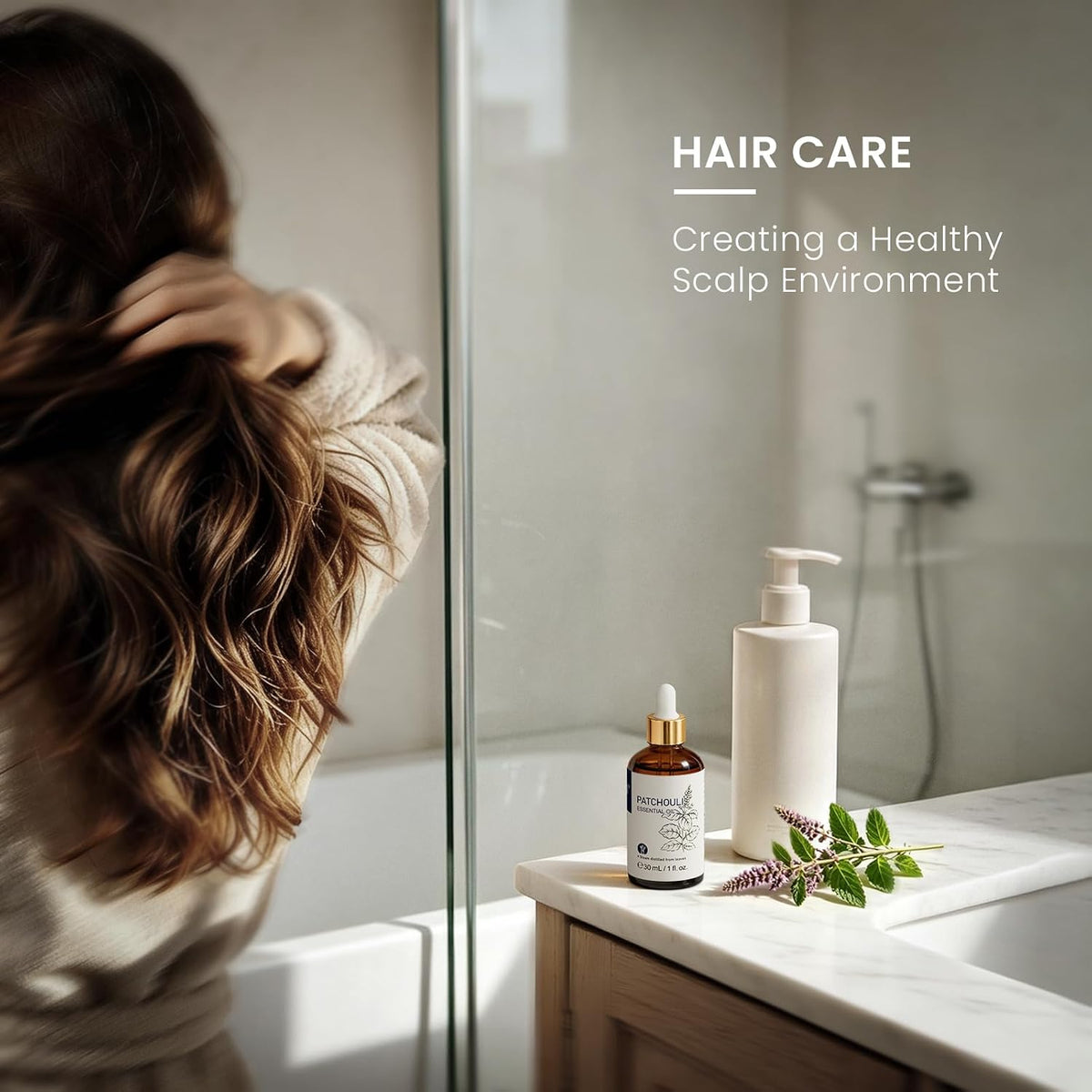 Woman in a bathroom using patchouli essential oil in a hair care routine