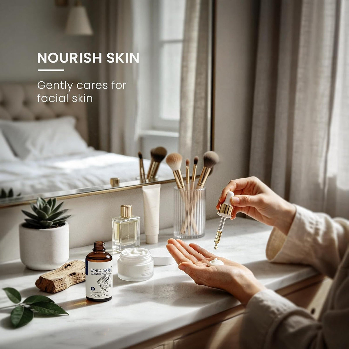 Woman at a dressing table adding sandalwood essential oil to a facial skin care routine