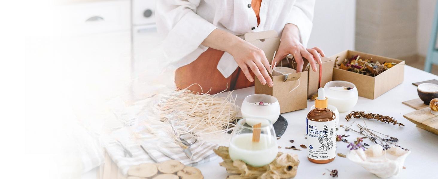 Woman making and packaging handmade scented candles using pure lavender essential oil, dried flowers, and natural wax for a relaxing home fragrance.