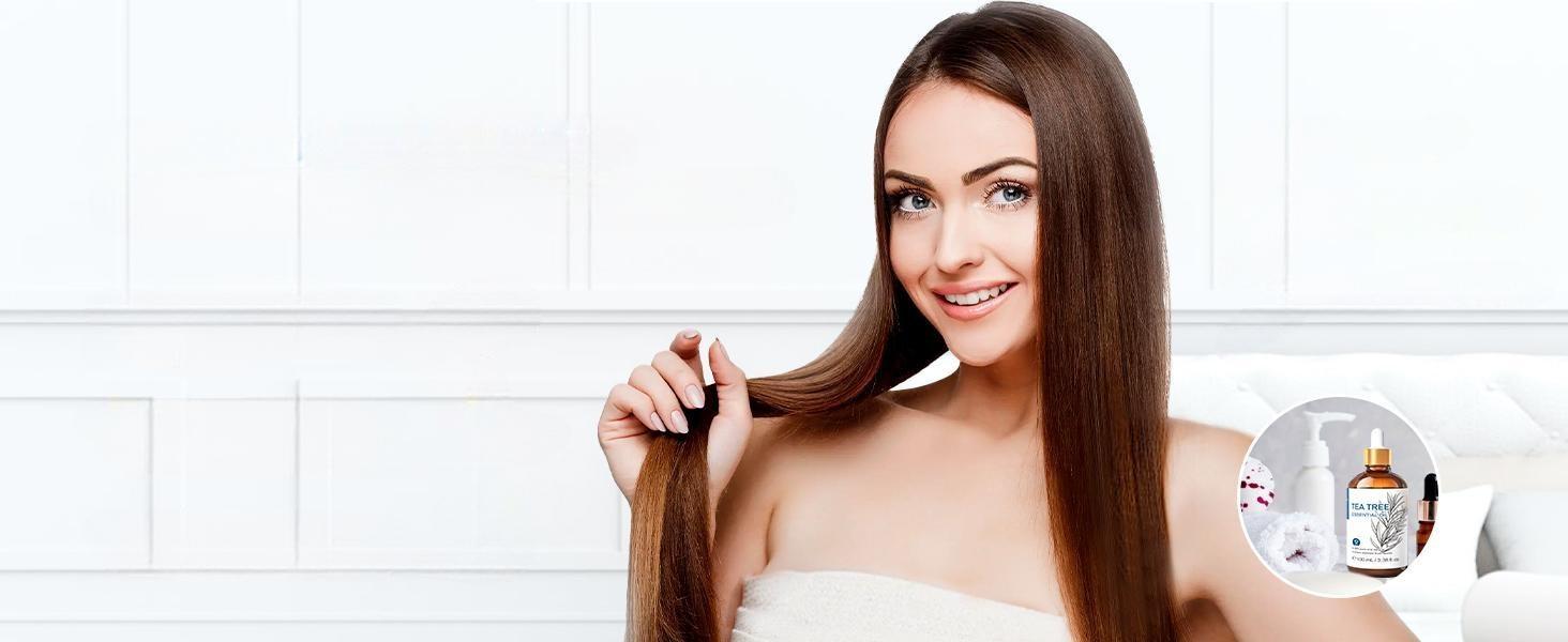 Woman with healthy, lustrous hair showcasing the scalp-soothing and oil-balancing benefits of adding pure tea tree essential oil to daily shampoo for hair loss and dandruff control.