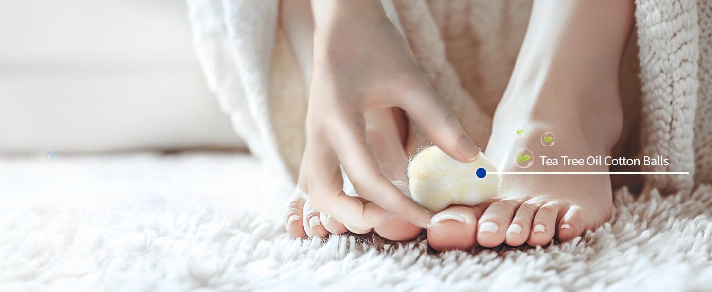 Person applying pure tea tree essential oil to toenails using a cotton ball for natural nail care and deep cleansing foot health.