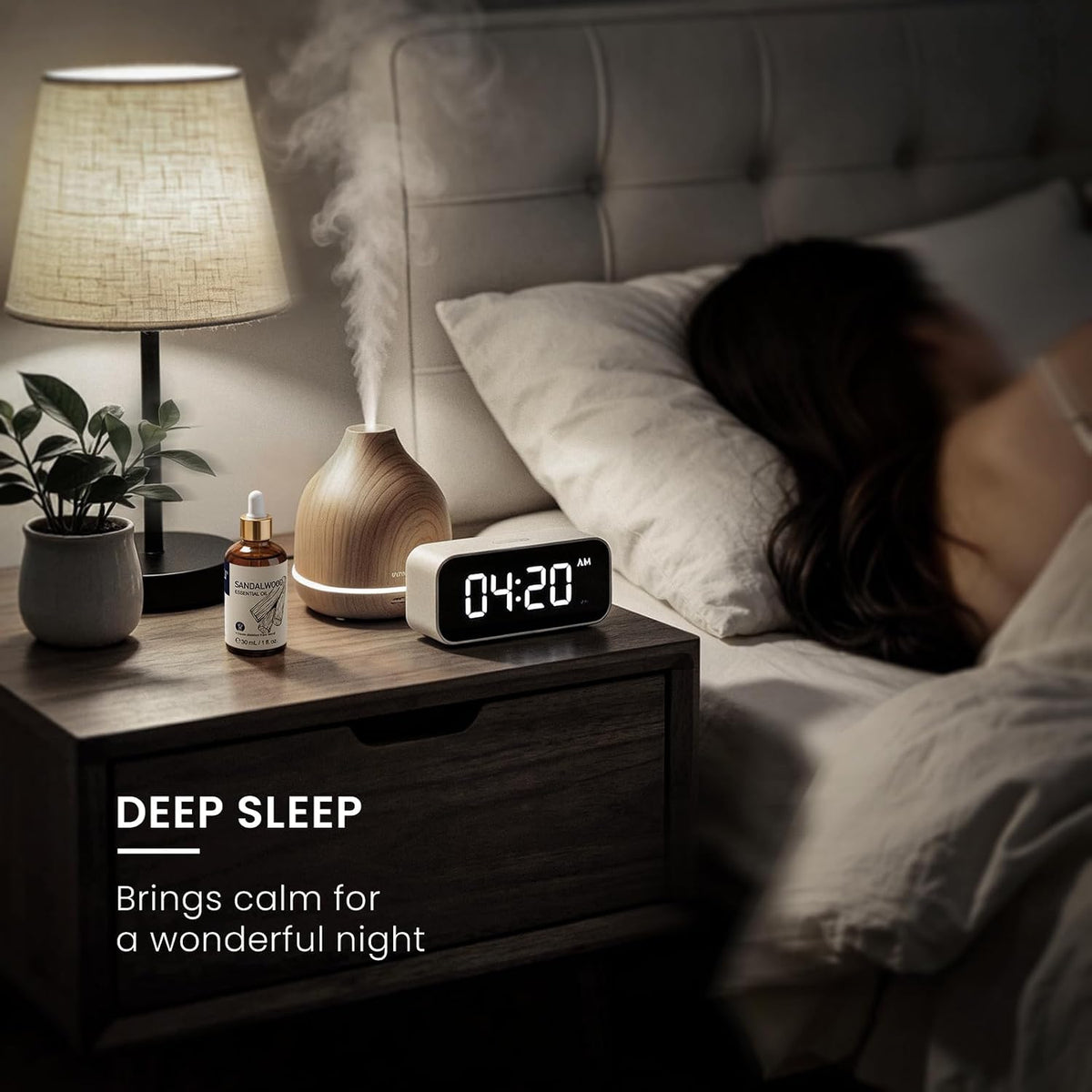 Bedside diffuser and clock beside a sleeping person using HIQILI Sandalwood Essential Oil