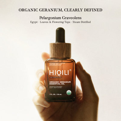 Hand holding a HIQILI organic geranium essential oil bottle labelled Pelargonium graveolens from Egypt