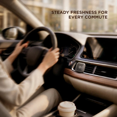 Vent air freshener clipped to a center console blower while a driver holds the wheel on a morning commute