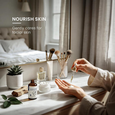 Woman at a dressing table adding sandalwood essential oil to a facial skin care routine