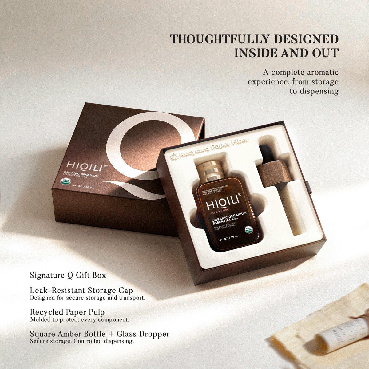 Open HIQILI signature Q gift box with geranium oil bottle, storage cap, glass dropper and paper pulp insert
