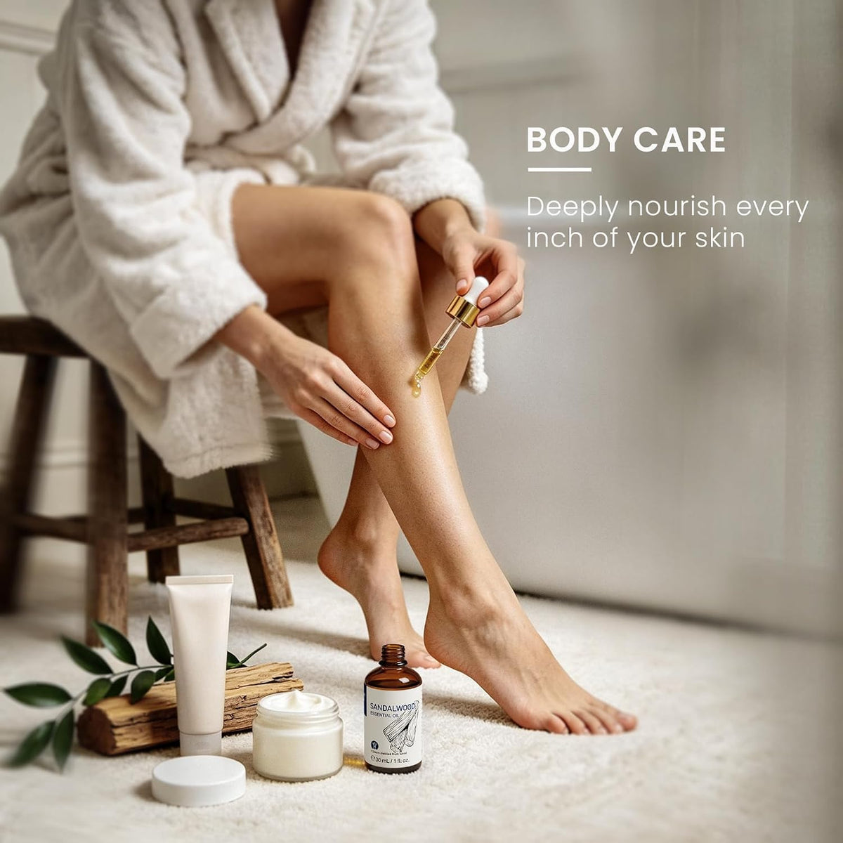 Woman massaging diluted sandalwood essential oil into her legs after a bath