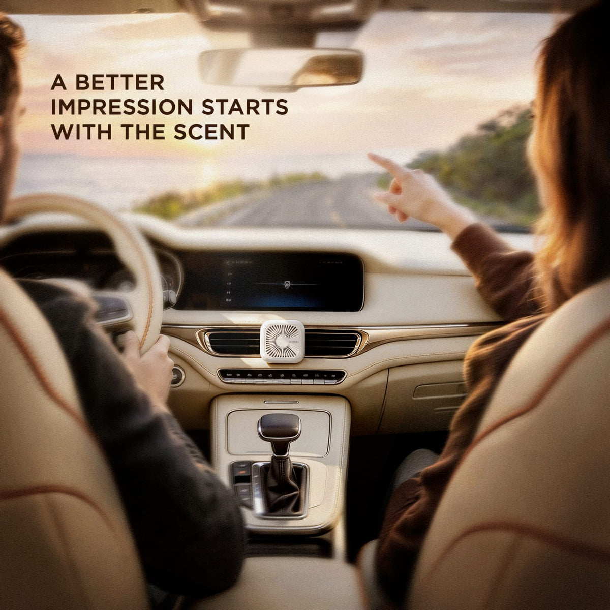 Ivory white car freshener on the center vent at sunset, with a passenger pointing at the road ahead