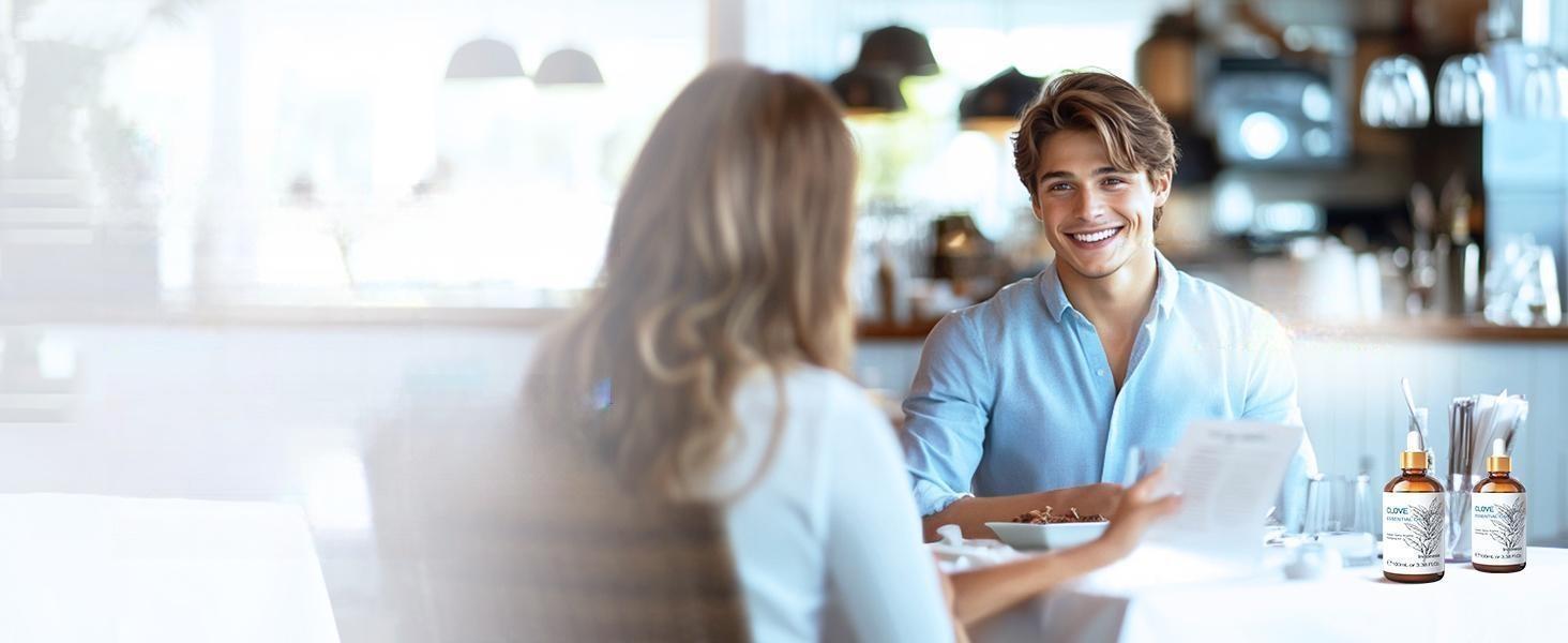 Smiling couple on a date showcasing the benefits of using pure clove essential oil as a natural, chemical-free mouthwash for fresh breath.