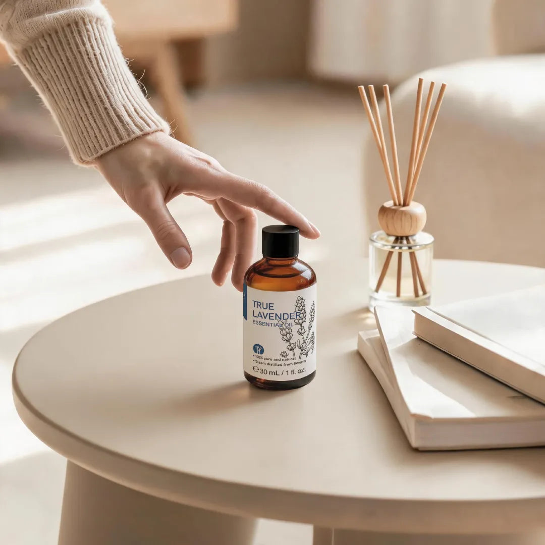 HIQILI True Lavender Essential Oil displayed beside a reed diffuser in a warm minimalist home setting.