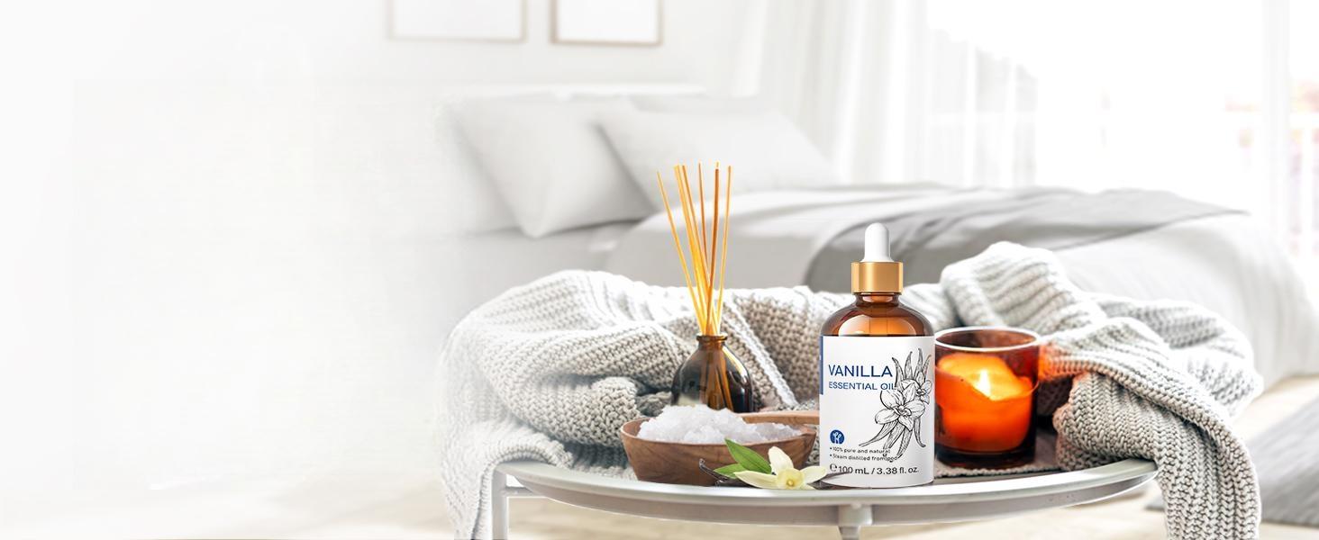 Cozy bedroom setup featuring pure vanilla essential oil used for natural home fragrance with a reed diffuser, crystal salt rocks, and an unscented candle.